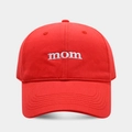 Close-up of white 'mom' embroidery on a red cotton baseball cap with reinforced stitching - Adjustable / Red