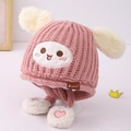 Rosa Strickmütze für Babys mit weißen flauschigen Ohren und lustigem Smiley-Aufnäher - Kinder / Rosa