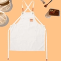 Waterproof cream canvas work apron with cross back straps and leather details - Snow White