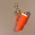 Orange Stanley cup style keychain with golden butterfly charm and silicone straw detail - Butterfly Orange