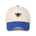 Detailed close-up of bee embroidery on a five-panel beige and blue trucker hat - Sapphire Blue