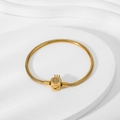 Detail of 18K gold snake chain bracelet with crystal-studded crown clasp on white background - Gold Crown Clasp