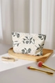 Detail shot of heavy canvas makeup bag with floral embroidery and gold zipper closure - Green Leaf Large