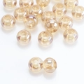Macro detail of champagne gold large hole glass beads with high gloss finish for jewelry DIY - Amber Gold