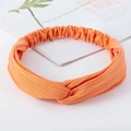 Bright orange ribbed knit twisted headband with elastic band for yoga and skincare - Knitted Orange