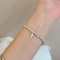 Minimalist silver bamboo link chain bracelet with delicate leaf pendant on wrist - Silver Bamboo Joint Leaf (MY30846)