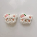 Detail showing two plush white bear accessories with cute strawberry embroidery details - Curly White Bear with Strawberry