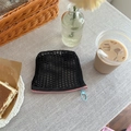 Black mesh storage pouch with pink zipper and blue round puller in a cozy setting - Black + Pink Blue Zipper