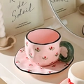 Detail of pink ceramic coffee cup with hand-painted berries and green handle - 340ml / Floral (Pink Base)