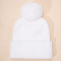 Detailed view of white knitted beanie with large fluffy pom-pom and folded cuff - One Size / White