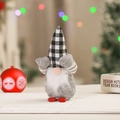 Macro detail of a plush Christmas gnome ornament with a black and white checkered hat - Gray