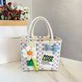 Pink and blue woven picnic basket bag with a white flower charm and blue bow detail - Sunflower Bow Decoration / Beige Main Color Vertical Stripe