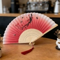 Elegant folding fan with red gradient plum blossom pattern and silk tassel - Style 58 (New Style)