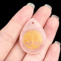 Waterdrop shaped pink quartz pendant featuring an intricate golden tree of life engraving - Rose Quartz