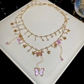 Macro detail of double-layer necklace with gold butterfly charms and purple resin wings - Gold Necklace (Purple Butterfly)