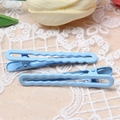 Set of two light blue wavy metal hair clips on a soft beige lace fabric background - Sky Blue