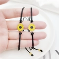 Detail of friendship bracelets with sunflower charms and adjustable black woven cords - Sunflower Black Wax Cord Set / Black
