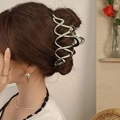 Silver metallic butterfly wave hair claw clip worn by a model in a stylish updo hairstyle - Wave Streamline Interwoven Style / Large / Silver
