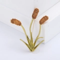 Minimalist gold reed brooch pin for women on a white geometric display stand - Orange (MM-BR-1377)
