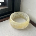 Wide geometric resin bangle with yellow and white marble texture on a grey fabric base - Milk Tea