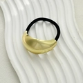 Minimalist gold curved metal hair tie with black high-elastic band on a white tray - Large Oval Gold