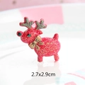 Macro detail of a 2.7x2.9cm red glitter reindeer resin charm with a gold bow accent - Red Reindeer