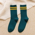 Knitted green socks with yellow stripes on beige background for casual autumn style - One Size / Green