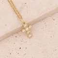Macro shot of 18K gold plated cross pendant with cubic zirconia on a stone surface - Smooth Round Zirconia Row Inlaid Cross (7#)