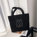 Close-up of black corduroy tote bag featuring a cute white rabbit embroidery and soft texture - Rabbit Carrot Black