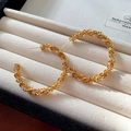 Detail shot of golden textured hoop earrings with a pleated surface finish in a jewelry box - 16# Crumpled Scale Texture Style