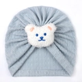 Close-up of baby knit turban hat featuring a 3D plush bear on soft blue fabric - One Size / Blue