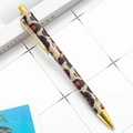 Click-action metal ballpoint pen featuring a leopard print barrel and gold-tone accents - Gold Leopard Print