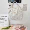 Detail of floral canvas tote bag with cat prints and colorful woven handles - Printed Cat White
