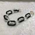 Detail of acrylic bee chain with black and translucent frosted links and gold ring clasps - Frosted Black
