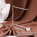 White L-shaped metal jewelry display stand for necklaces and earrings on dark fabric - 1-Tier Rack / White