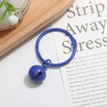 Close-up of blue lacquer metal ring with matching bell charm for DIY accessories - Sapphire Blue