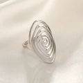 Detailed view of silver hammered ring with hollow spiral design on cream silk fabric - Round Hollow Line / Silver