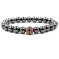 Detailed shot of dark grey hematite beads with a rose gold accent and black gemstone - Rose Gold Black Rhinestone Ball