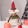 Santa Claus drawstring gift bag with red knit hat and green patterned fabric body - Santa Claus Apple Bag