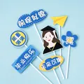 Blue graduation cake toppers set with cute characters and celebratory text banners - Stay Motivated