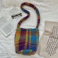 Macro view of colorful checkered faux lamb wool tote bag with soft plush texture details - Multi Color Grid
