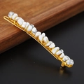 Detail of white crystal stones hand-wrapped with gold wire on a metal hair clip - Howlite + Gold Clip