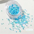 Close-up of mixed size light blue iridescent mermaid glass beads for nail art design - Mocha Lake Blue