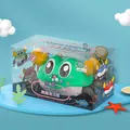 Inertia crab toy in cyan with cartoon eyes and orange claws in a sea theme display - Color Box / Green