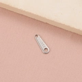 Macro shot of stainless steel tag with S.STEEL engraving for DIY jewelry making - Oval S.Steel Tag (4#) / Steel