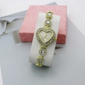 Detail of a gold heart-shaped watch face with sparkling rhinestones and quartz movement - Gold White