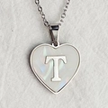 Silver heart necklace with letter T pendant and white shell inlay on a white linen surface - Letter T / Silver