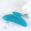 Teal glitter acrylic shark hair claw clip on marble background for hair styling - Blue