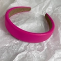 Close-up of rose pink padded headband with lychee grain leather texture and soft inner lining - Rose Red