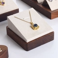 Golden necklace with blue gemstone pendant displayed on a walnut jewelry stand - Walnut White 09